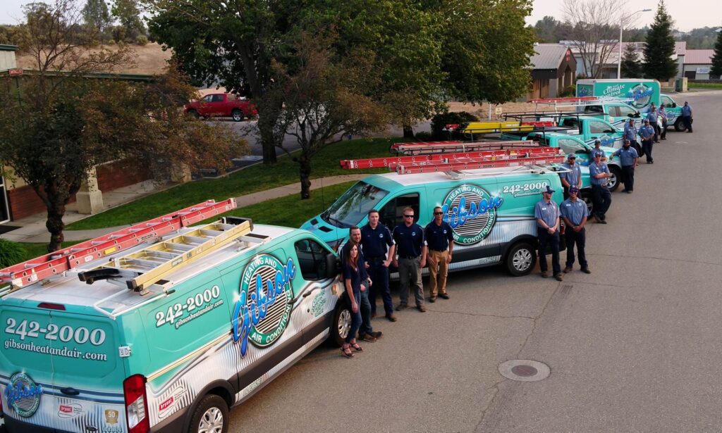 Gibson fleet of trucks and staff