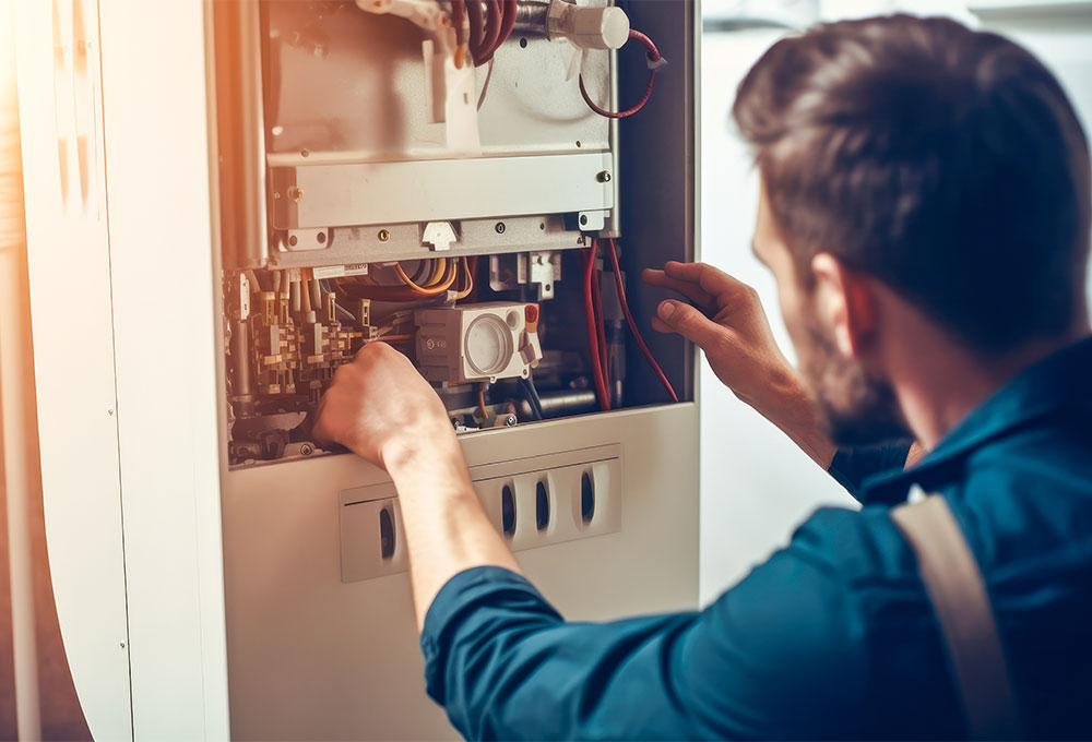 tech doing maintenance on a furnace