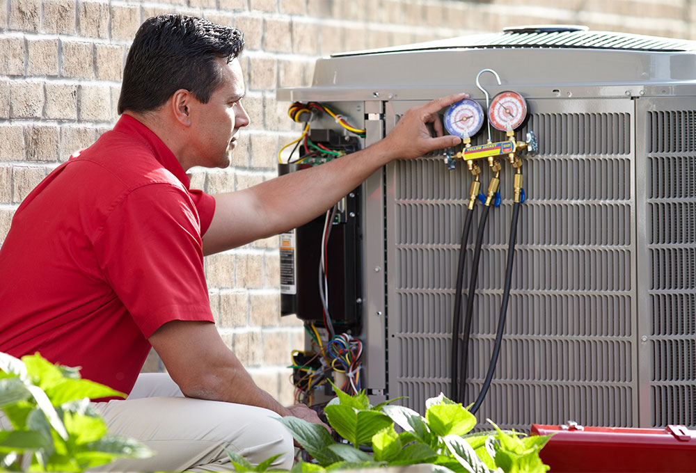 Using a gauge to check on a heat pump
